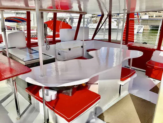 Catering setup and beverage bar inside the catamaran cabin for group parties