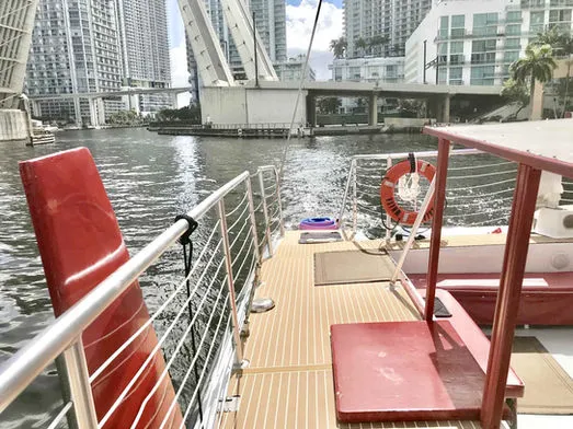 Side deck view of 60ft Catamaran Mariah cruising along the Miami River near downtown