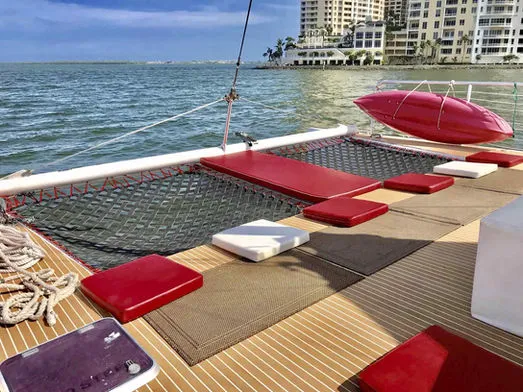 Close-up of the bow netting and kayak on the railing of the 60ft Catamaran Mariah