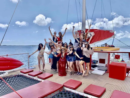 Large group of friends celebrating on the spacious bow deck of 60ft Catamaran Mariah in Miami