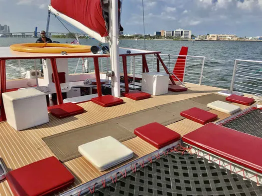 Spacious bow deck with red and white cushions and netting on 60ft Catamaran Mariah in Miami