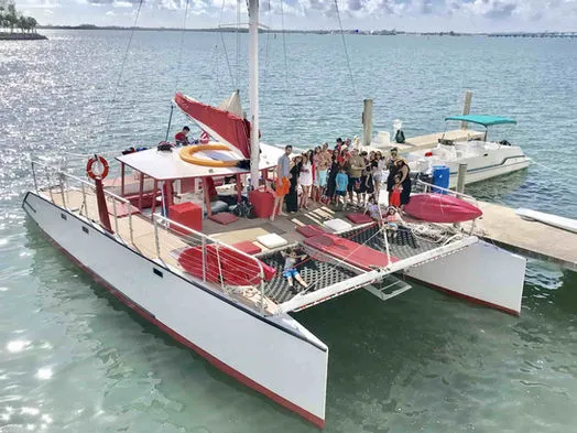 High-angle view of the 60ft Catamaran Mariah at the dock with a large group