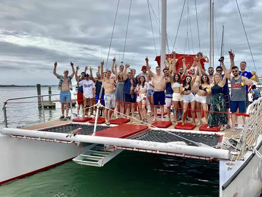 A group of passengers celebrating at the bow of the 60ft Catamaran Mariah in Miami