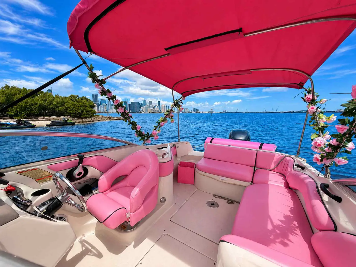 26ft pink Sea Ray Miami helm seat with the Miami skyline across the bay