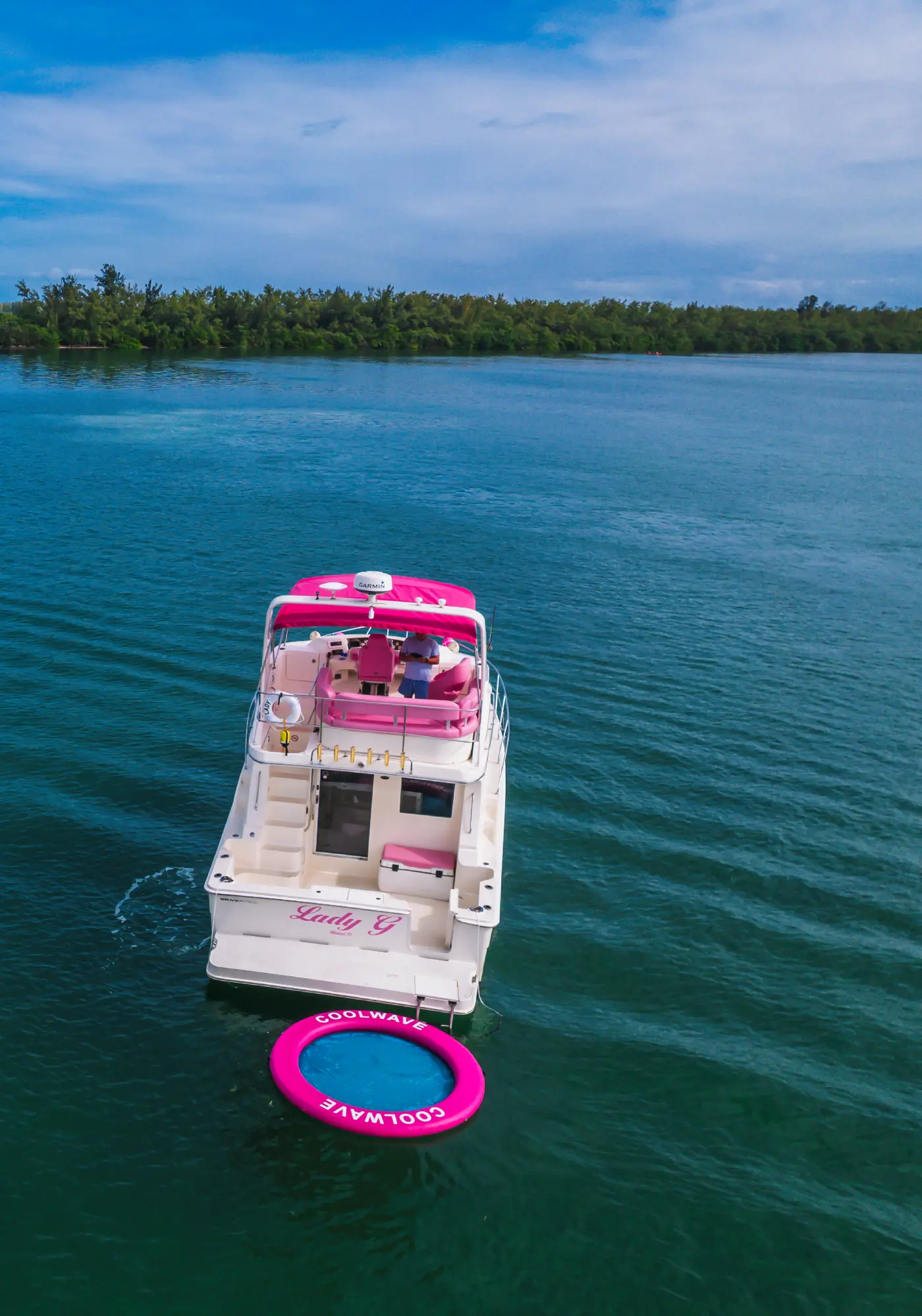 Aerial view of 41ft pink Silverton yacht Miami anchored with pink floating mat