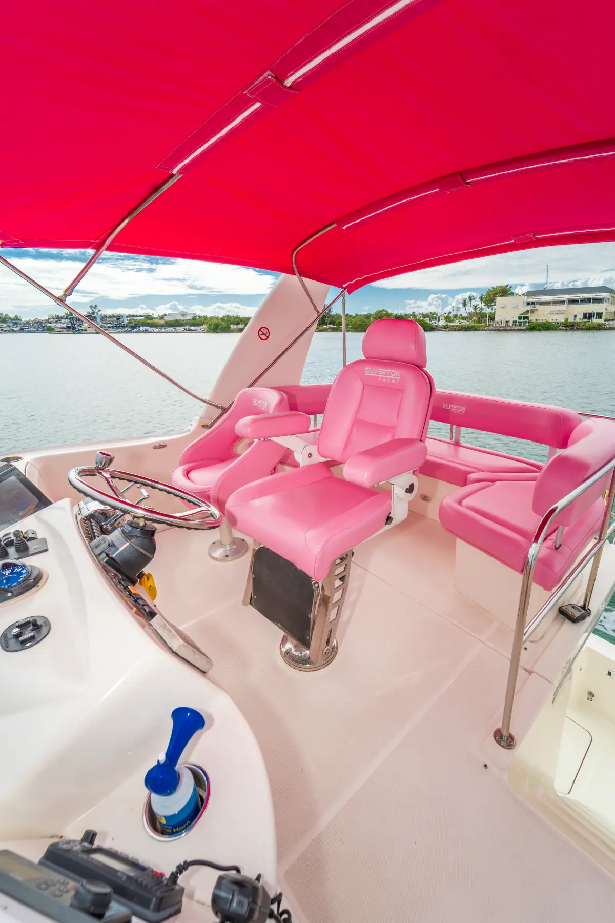41ft pink Silverton yacht Miami flybridge helm under a pink canopy