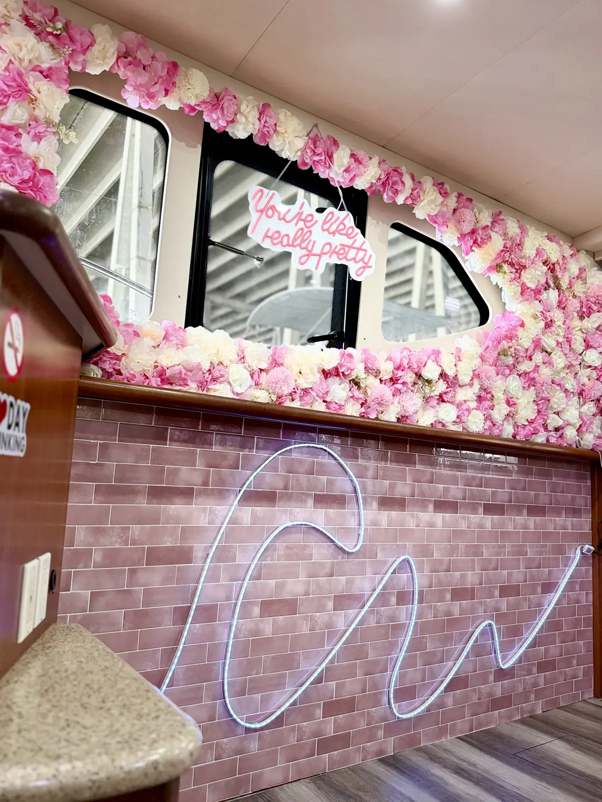 41ft pink Silverton yacht Miami neon sign on a pink brick wall with flower decor