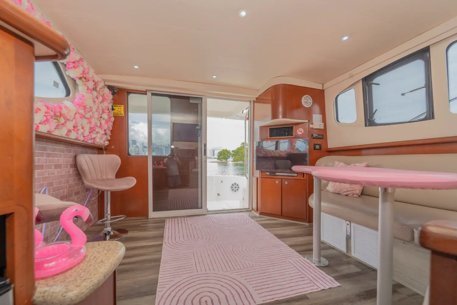 41ft pink Silverton yacht Miami salon with pink table and sliding door to the deck
