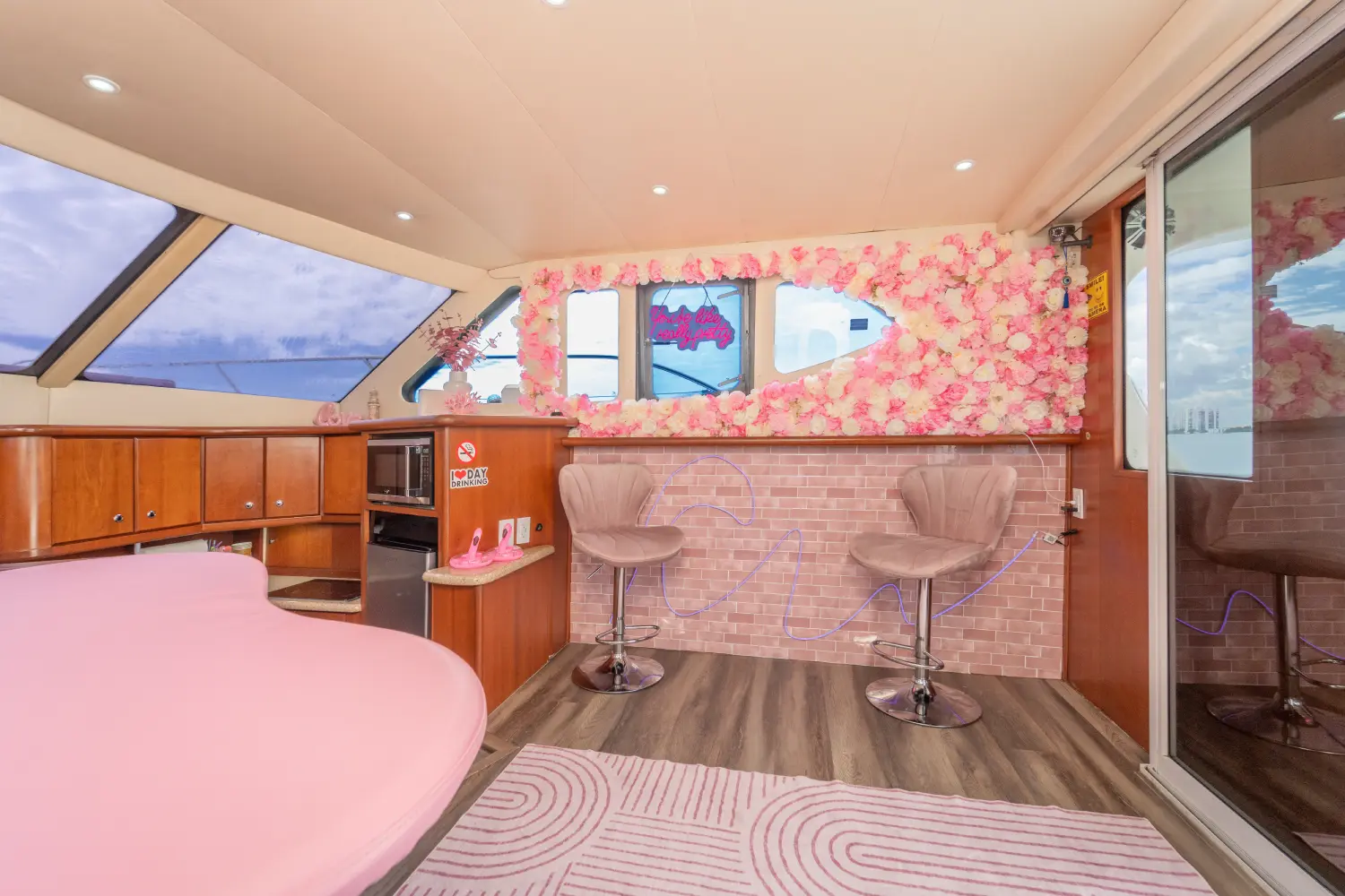 41ft pink Silverton yacht Miami salon lounge with pink rug and flower wall