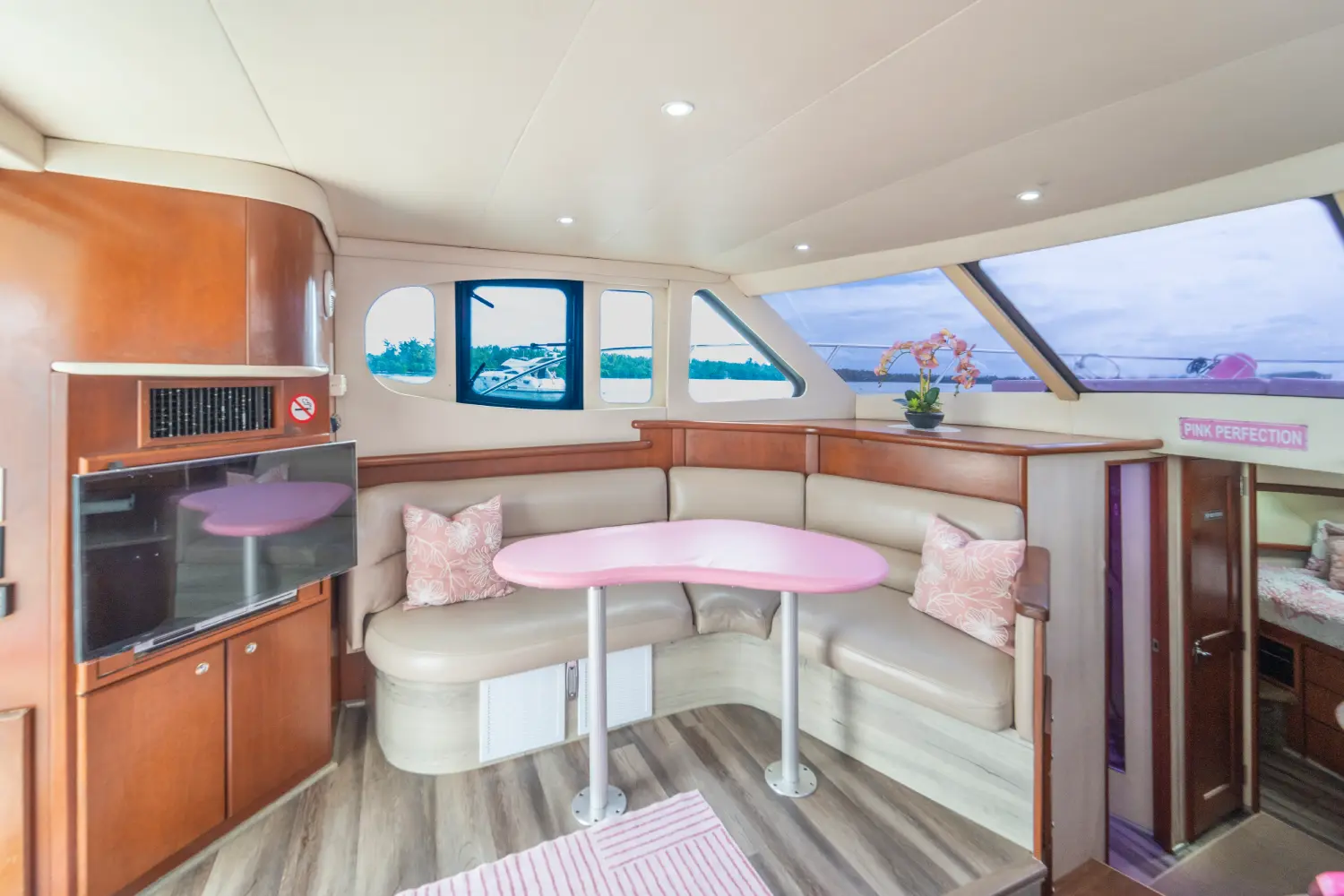 41ft pink Silverton yacht Miami salon seating with pink table and pillows