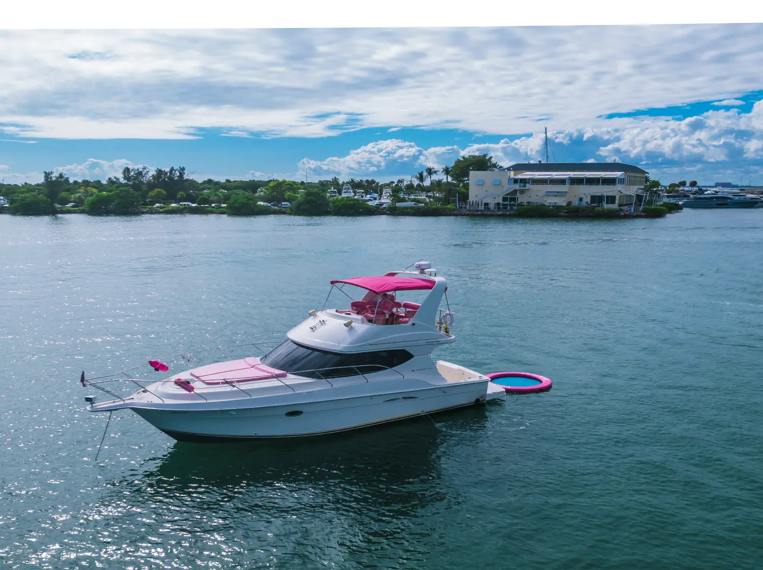41ft pink Silverton yacht Miami at anchor with pink canopy and floating mat
