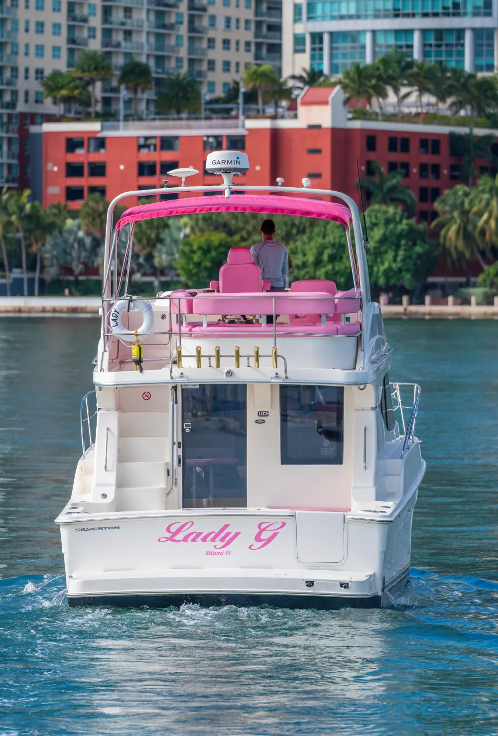 41ft pink Silverton yacht Lady G in Miami, stern with name and pink flybridge canopy