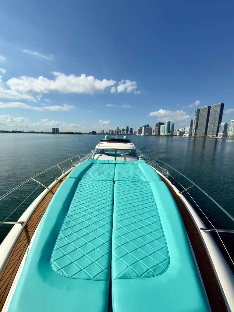 60ft Tiffany Predator yacht Miami bow sunpad in Tiffany blue facing the city skyline