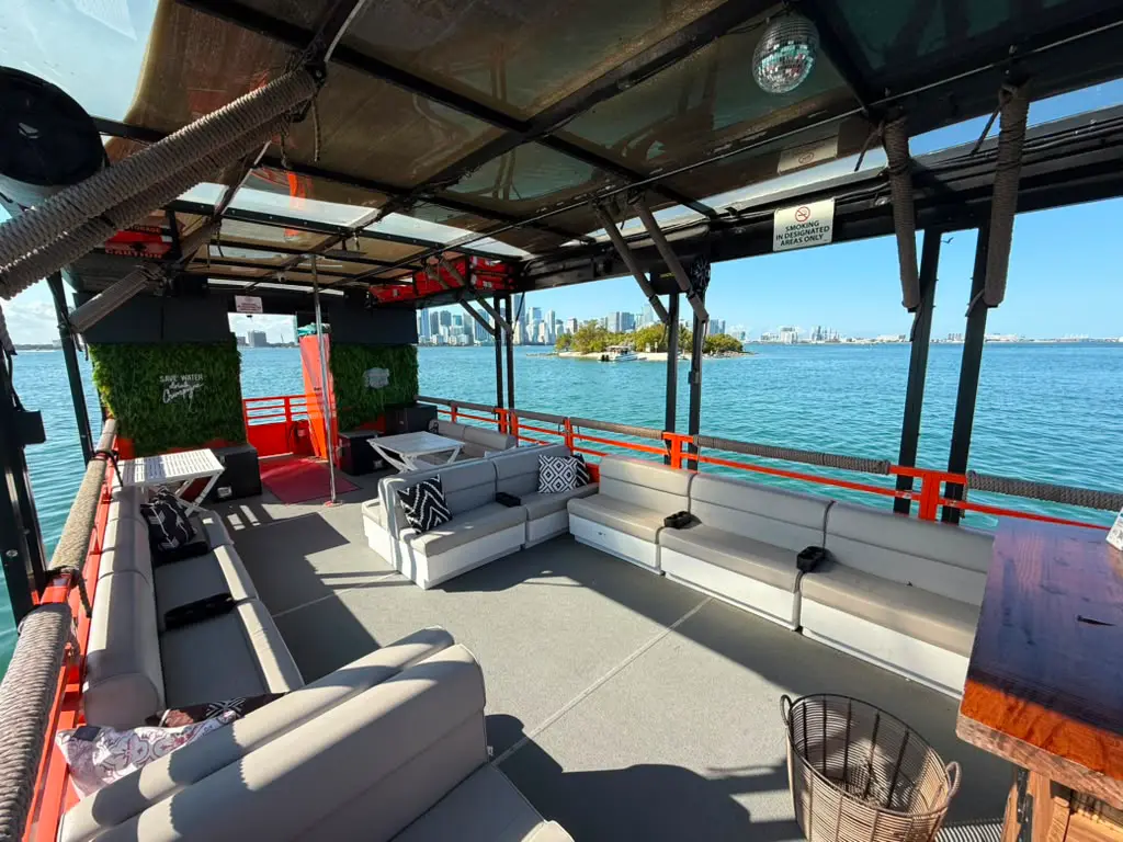 Cat Lux party boat cruising Biscayne Bay with panoramic Miami skyline views and shaded seating