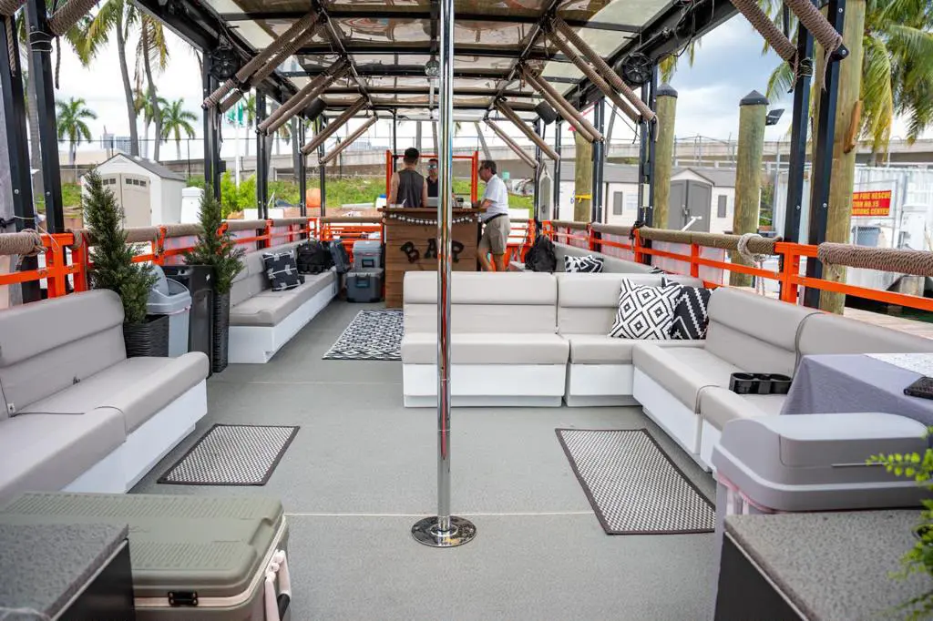 50ft Cat Lux party cruiser spacious open deck layout with plush lounge seating and dance pole in Miami