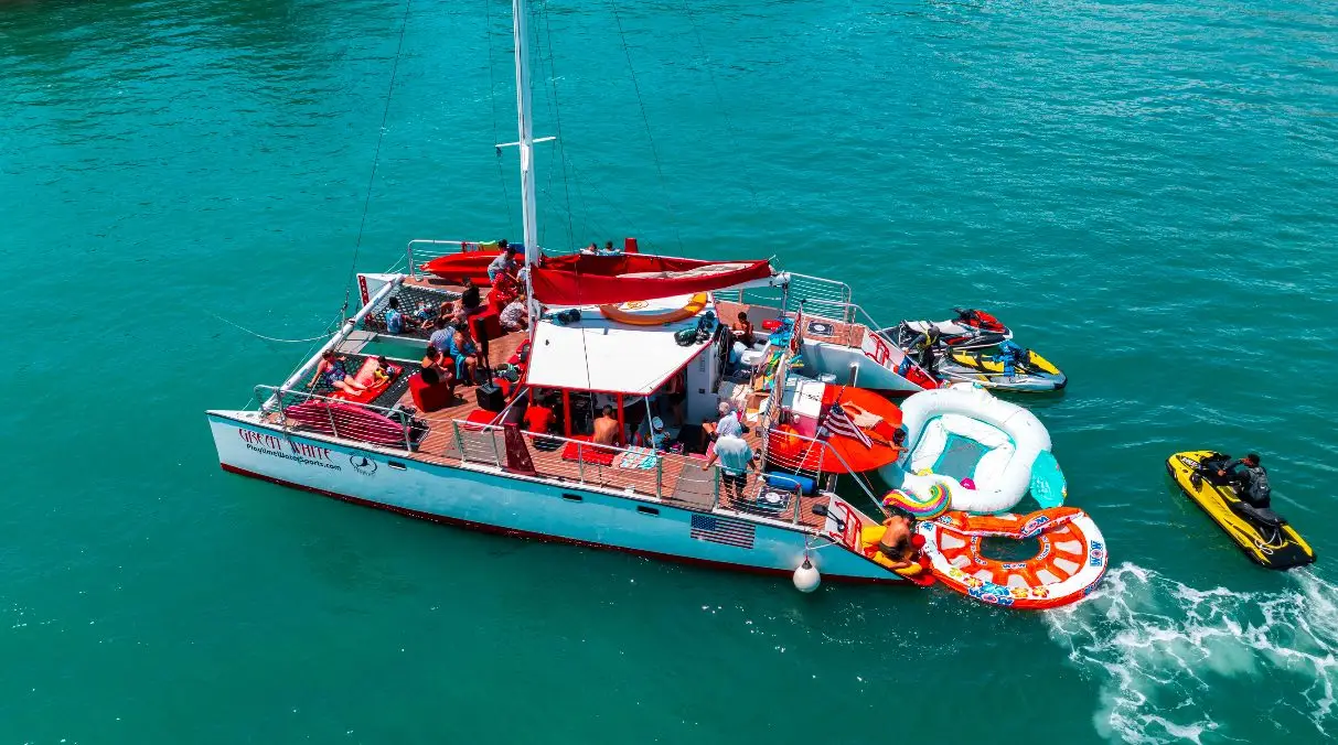 Guests enjoying water toys jet ski from catamaran charter Miami