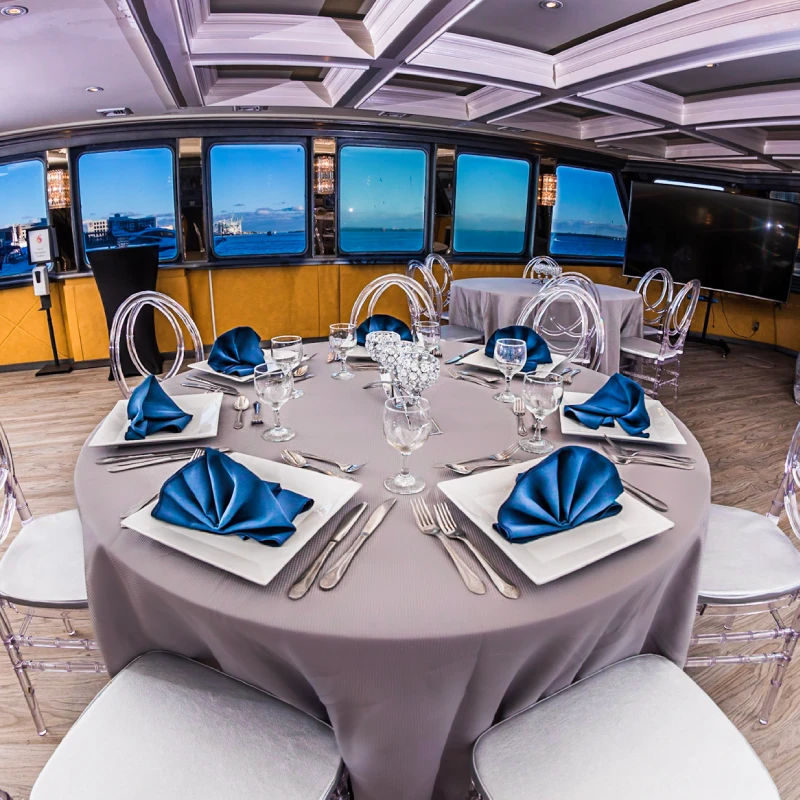Elegant dining salon setup for corporate event on yacht Miami