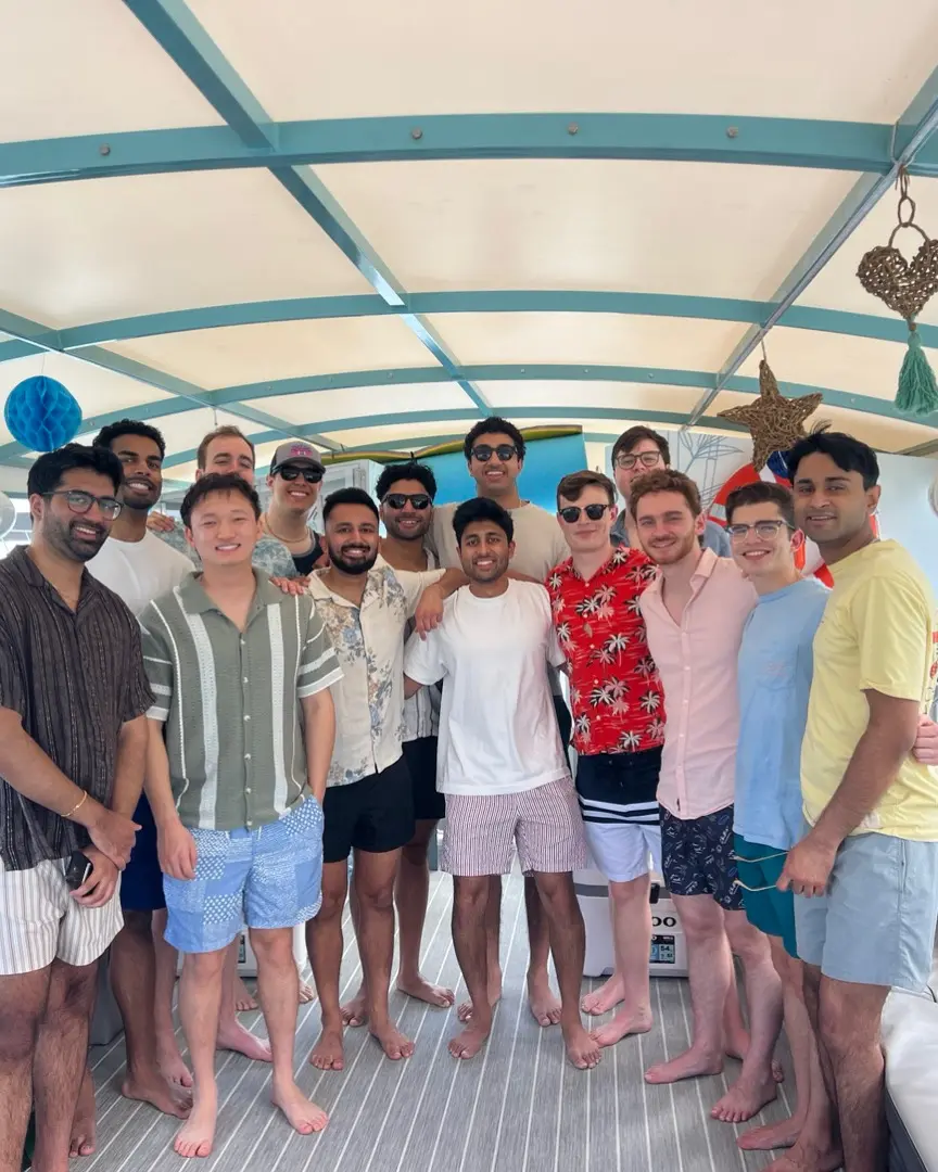 Group of men posing on covered deck of 35ft Moana Flow bachelor party boat in Miami
