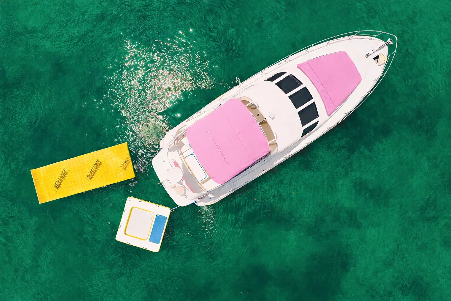 50ft Pink Horizon pink yacht rental Miami aerial view with aqua mat and water toys