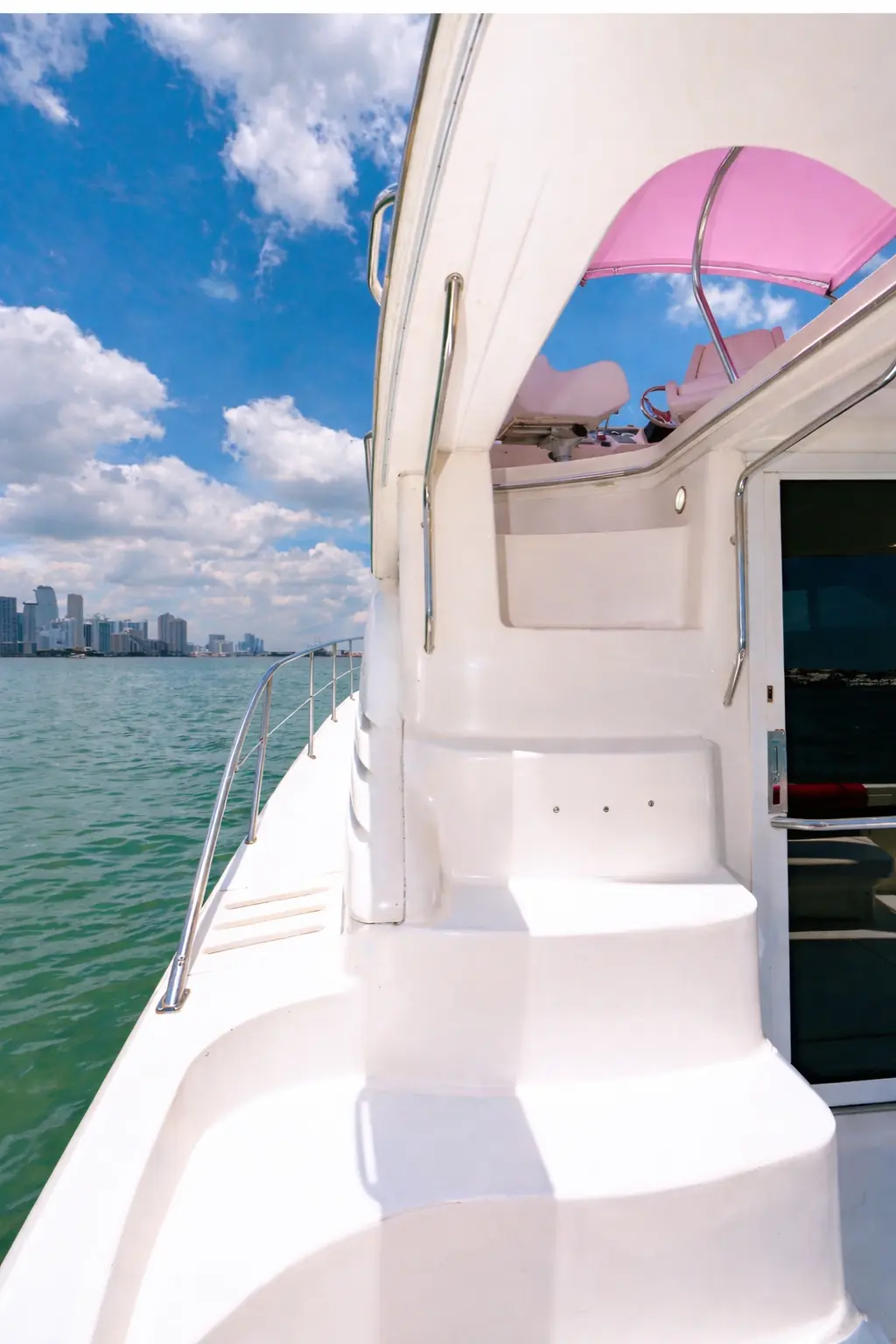 Pink Horizon yacht Miami flybridge deck with pink canopy and skyline view