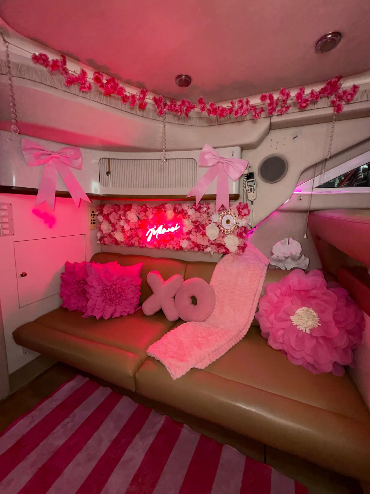 Pink Horizon yacht Miami interior with XO pillows and pink floral garlands