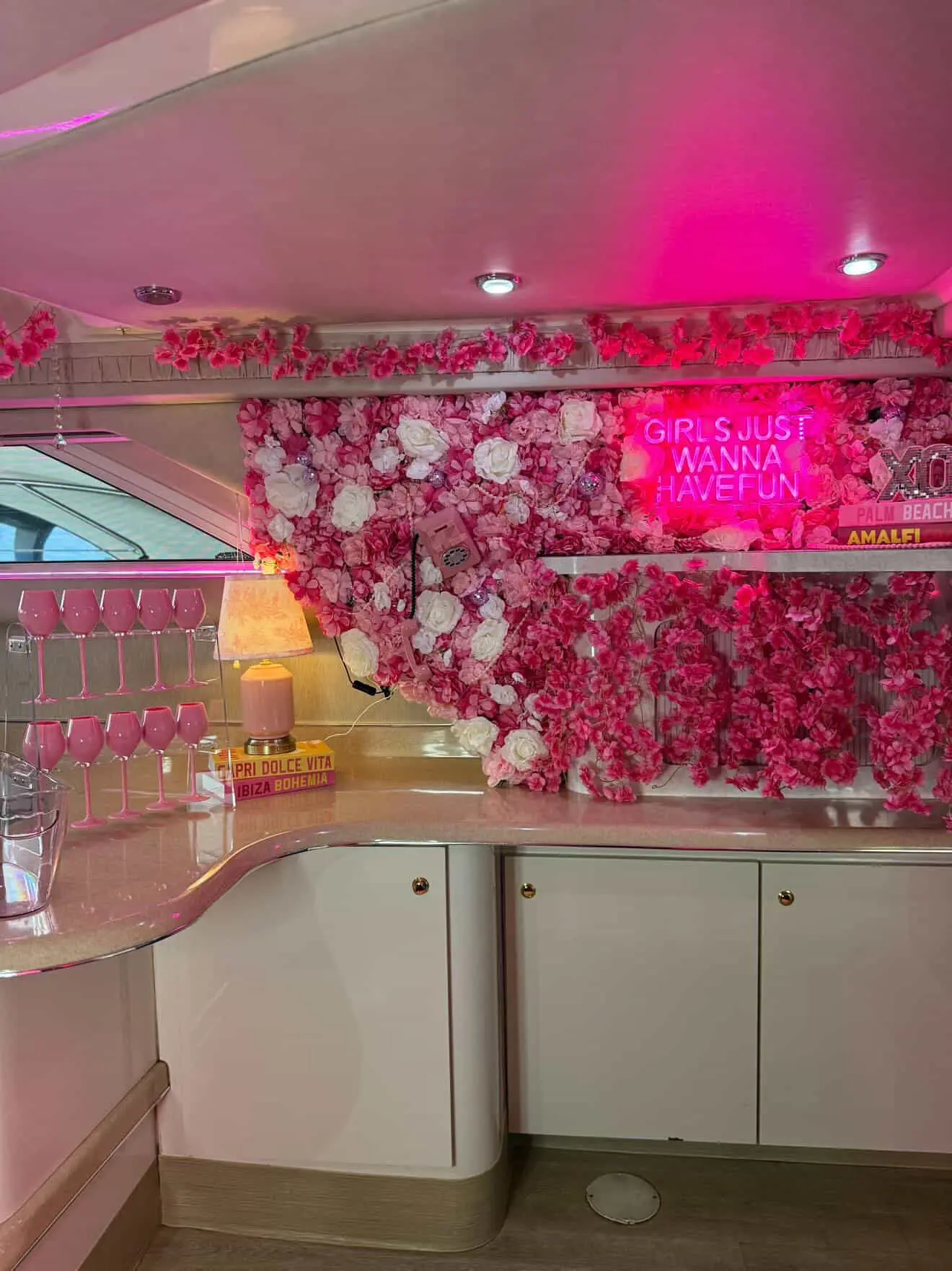 Pink Horizon yacht Miami bar area with pink wine glasses and neon lighting