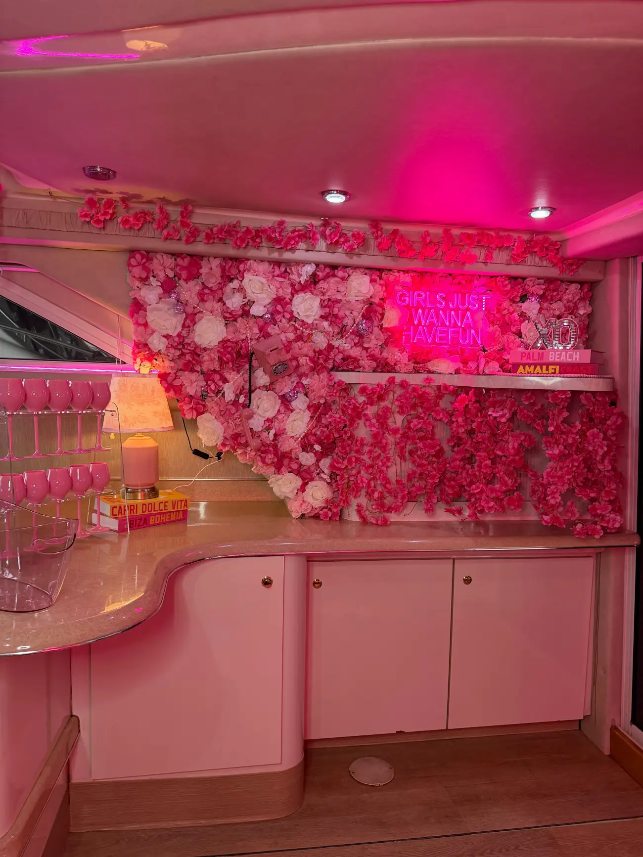 Pink Horizon yacht Miami onboard kitchen with pink floral wall and wine glasses