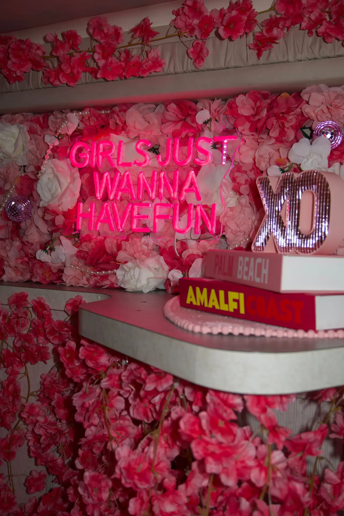 Pink Horizon yacht Miami interior neon wall with floral decor bachelorette party setup