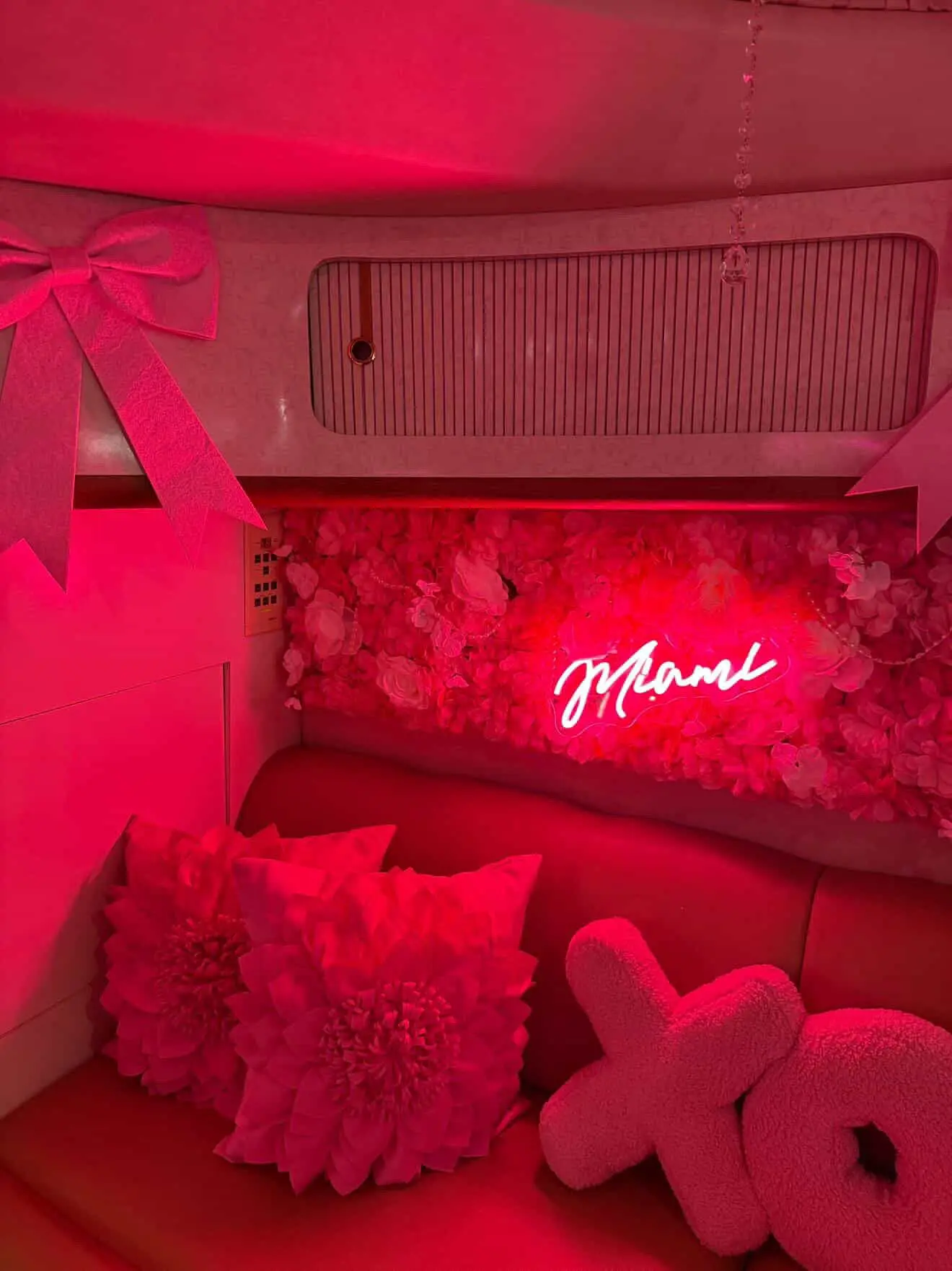 Pink Horizon yacht Miami lounge with Miami neon sign and pink pillows