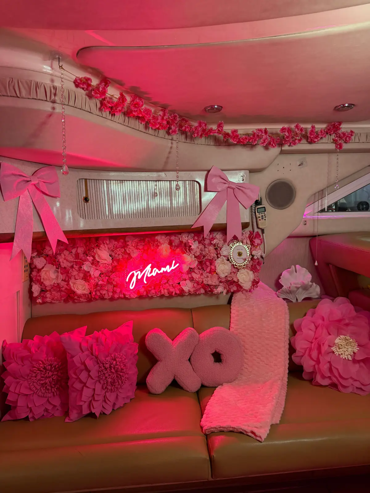 Pink Horizon yacht Miami interior salon with pink neon sign and floral wall decor