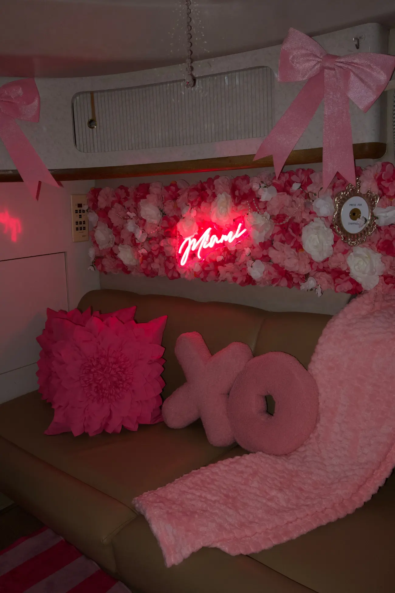 Pink Horizon yacht Miami salon with neon Miami sign and XO pillows