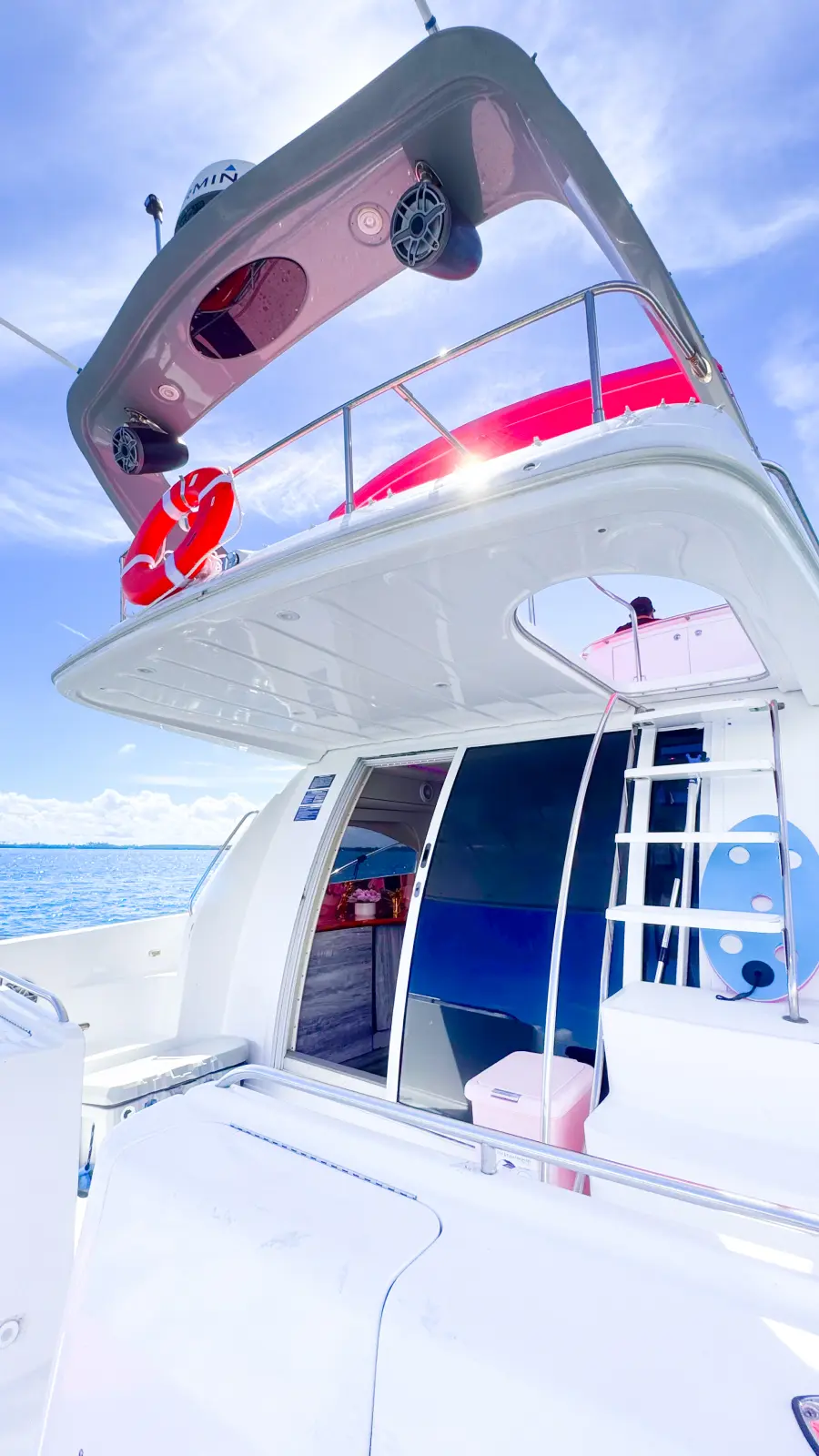 Aft deck and flybridge ladder on pink yacht rental Miami