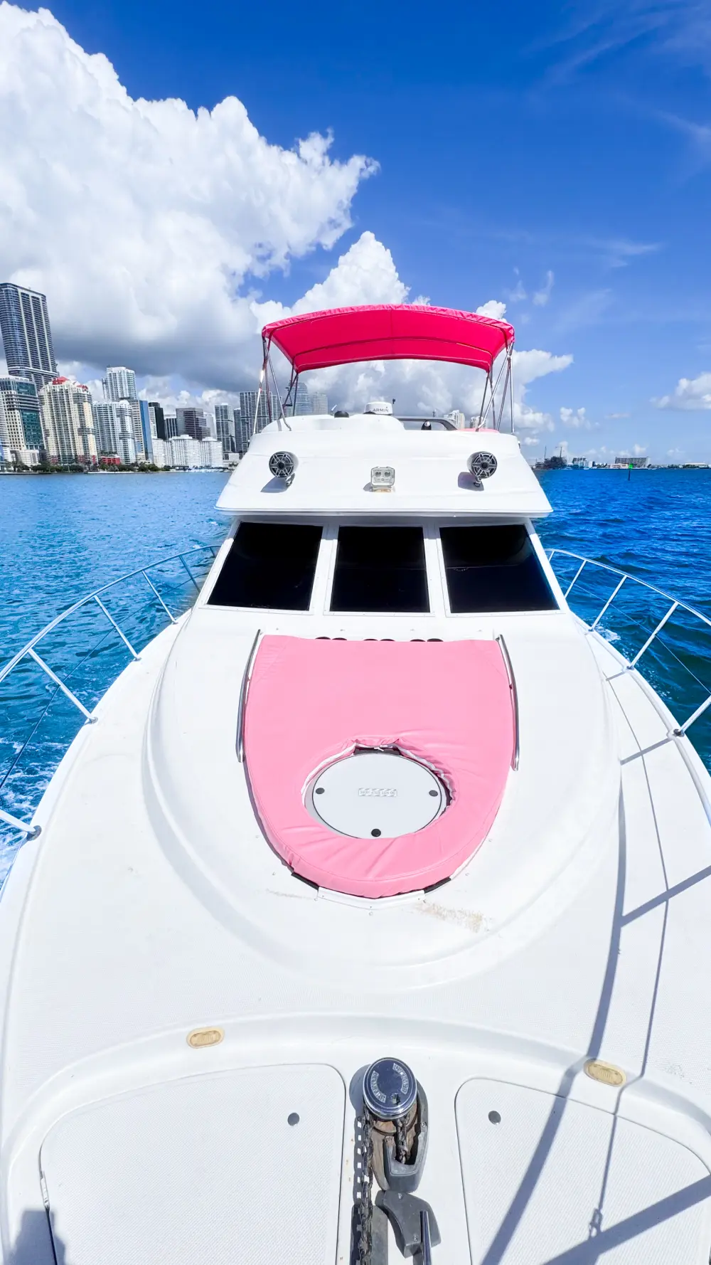 Pink bow pad on 46ft pink yacht Miami with Brickell skyline ahead