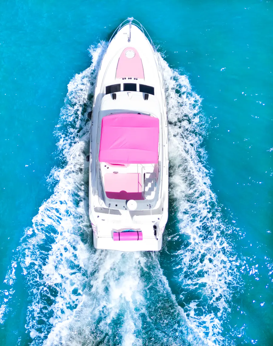 Pink Maxum yacht Miami bow and flybridge aerial photo with white wake