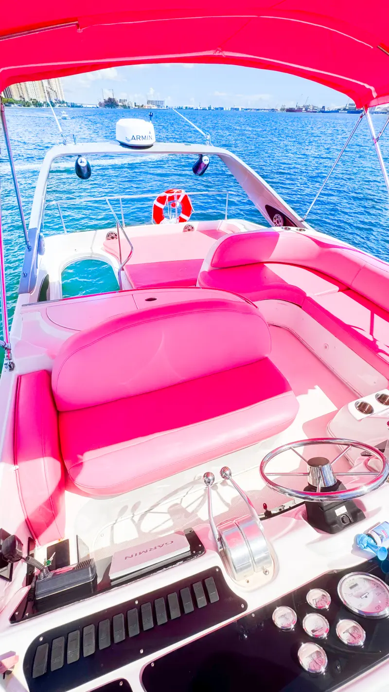 Flybridge seating on 46ft pink yacht Miami with pink cushions and canopy