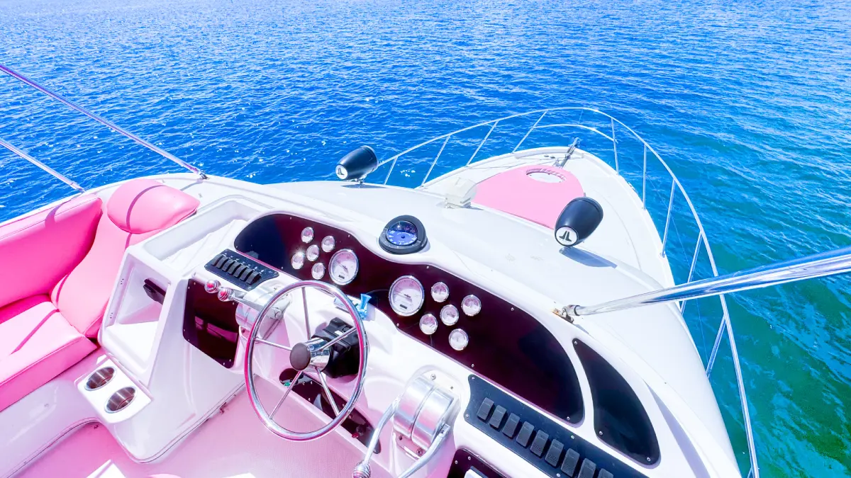 Helm of 46ft pink Maxum yacht Miami with pink seats over Biscayne Bay