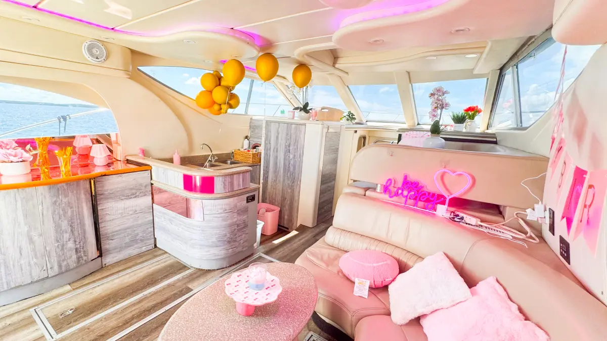 Pink Maxum yacht Miami salon with balloons and pink lounge for a birthday party